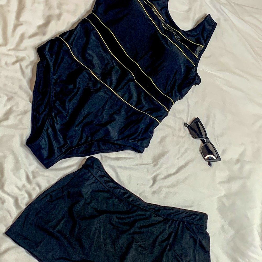 One piece bathing suit with skirt bottom.